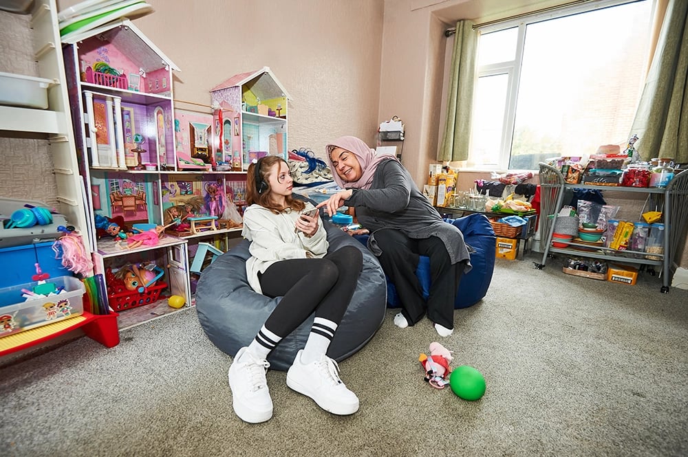 A parent tries to distract their teenager from their phone