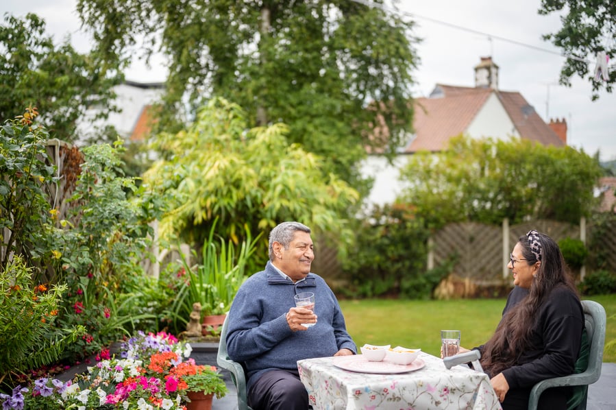 Mature couple enjoying a drink in their garden