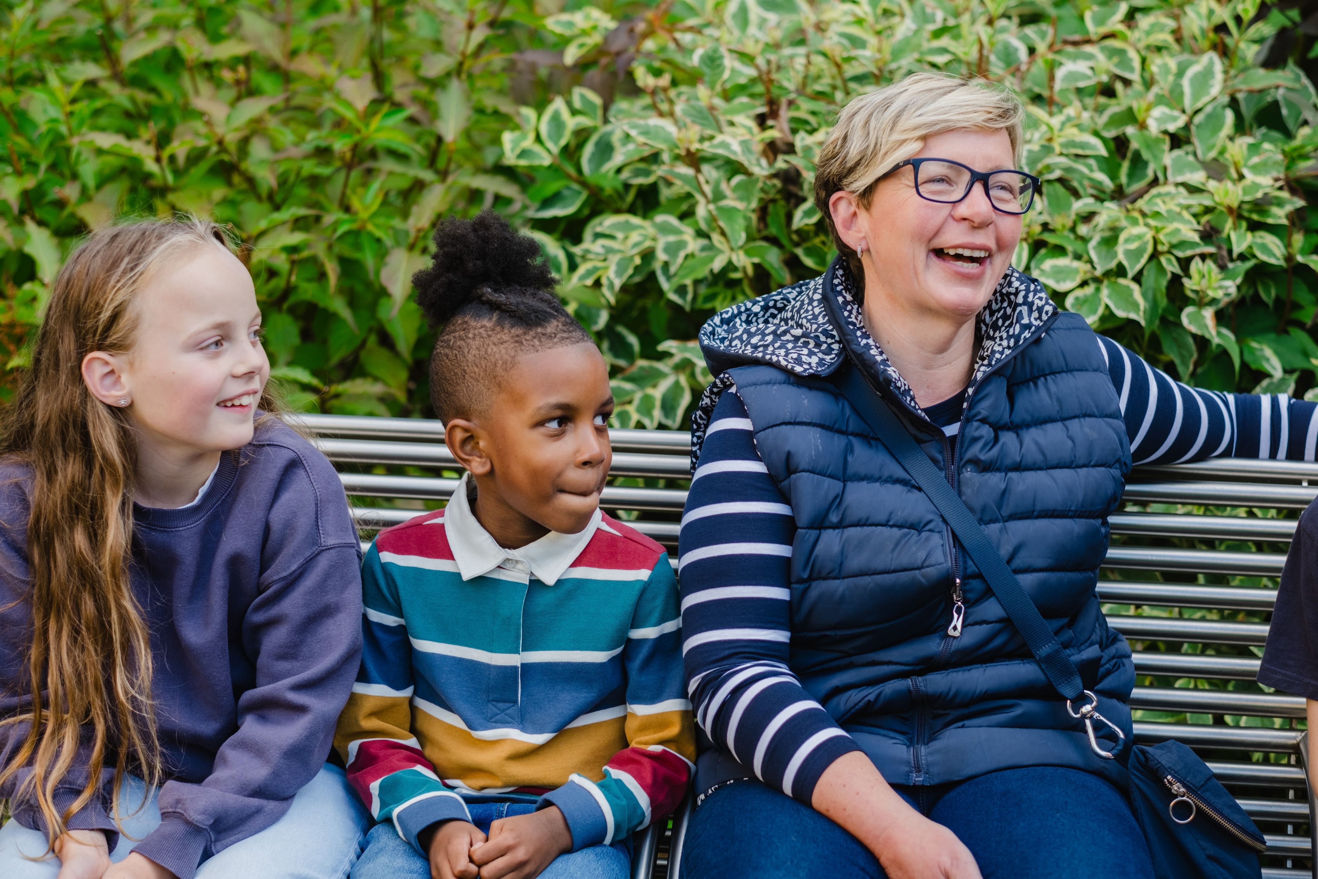 image of a foster carer and foster children in a park 