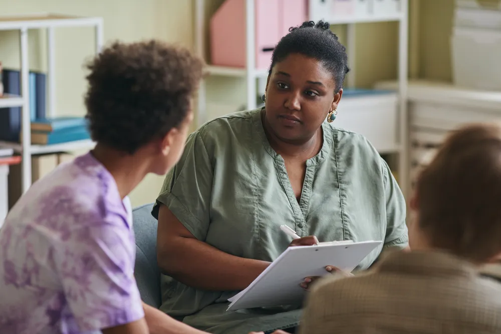 Woman talking to teenager